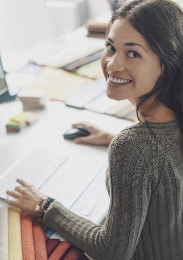smiling-interior-designer-working-at-desk-1.jpg